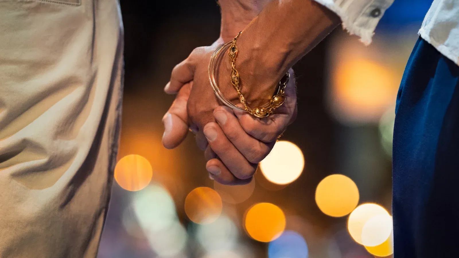 man and woman holding hands on a date night
