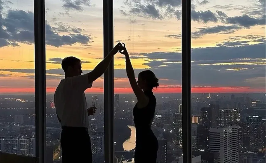 couple enjoying a date night with a skyline view