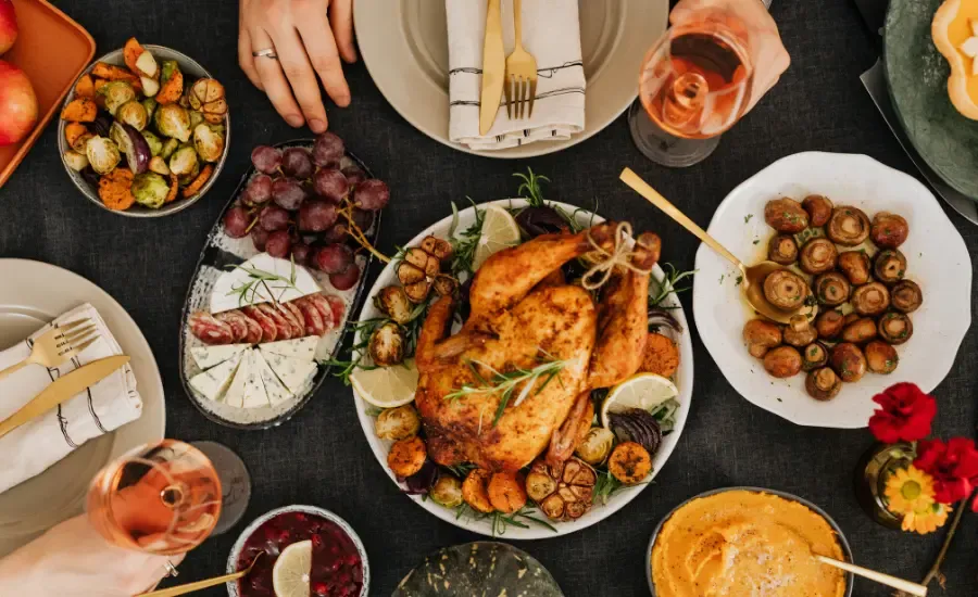 table with food, chicken potatoes and alcohol