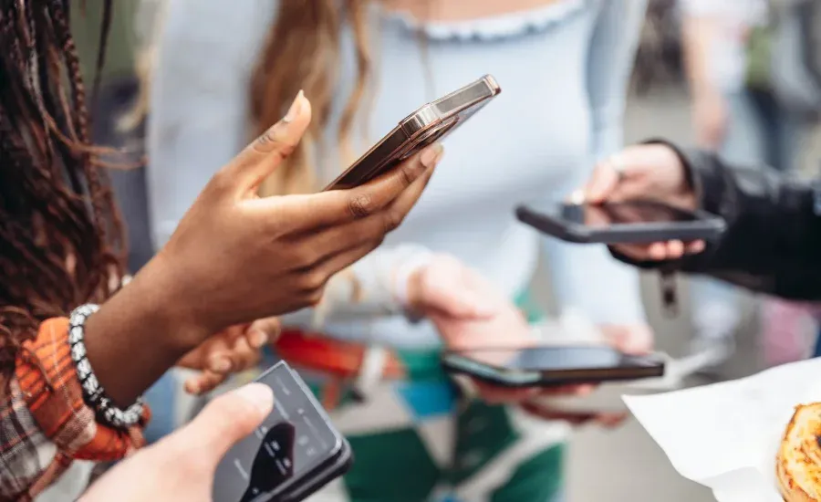 gen z people playing on their phones