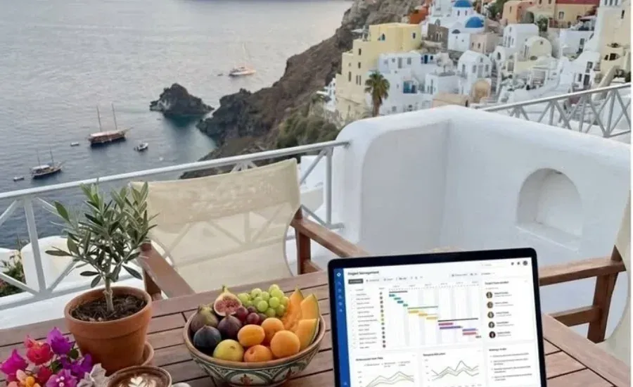 laptop with equity monitoring in Santorini island