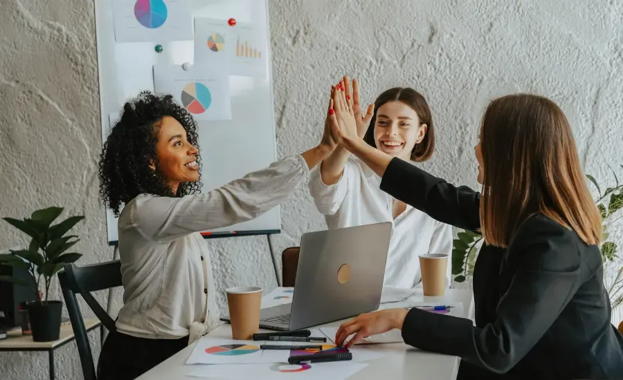 colleagues in a meeting high five