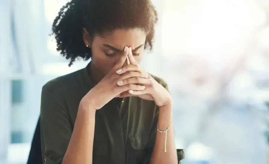 woman holding her head with her hands