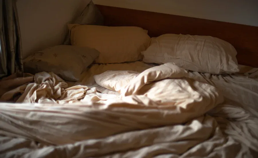 bed with beige sheets aesthetic