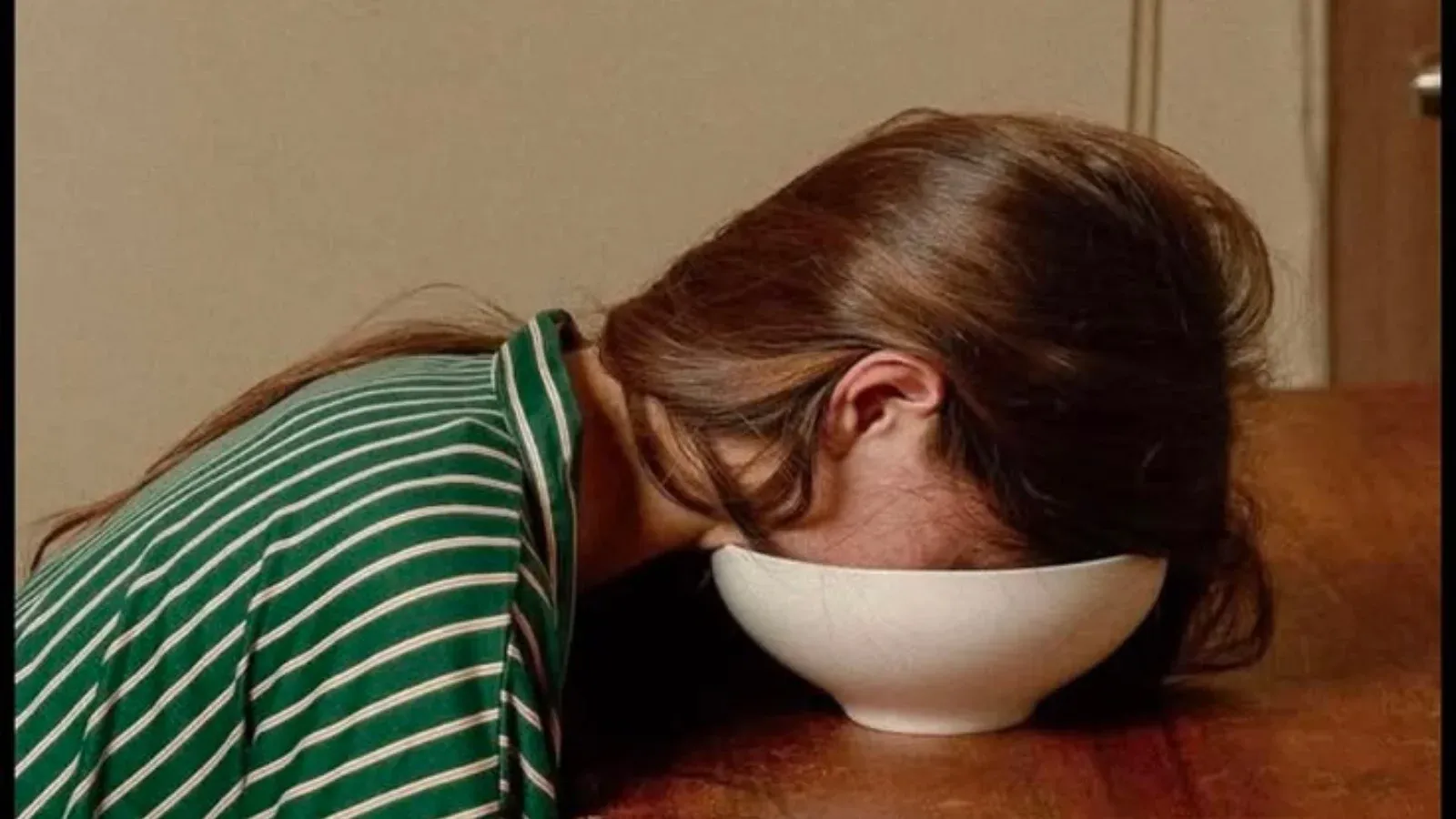 woman tired in keeping her face in a bowl