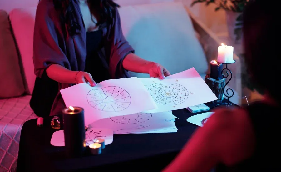 a woman showing another person an astrology map