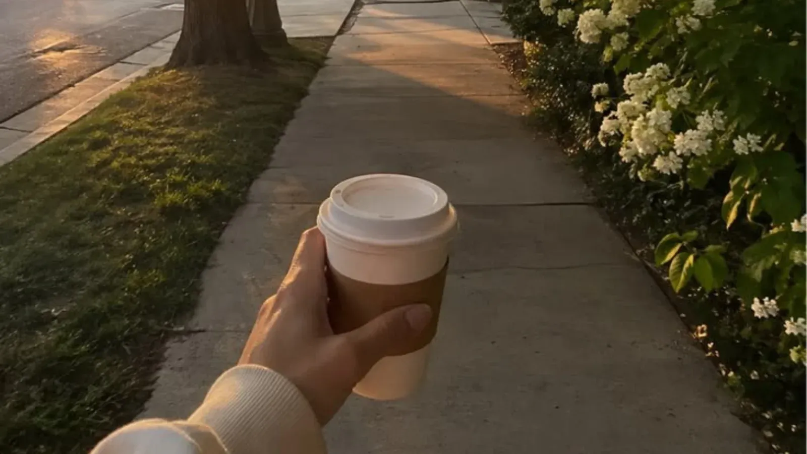 woman holding a cup of coffee outdoor walk